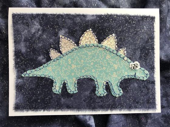 blue festive stegosaurus christmas card on navy