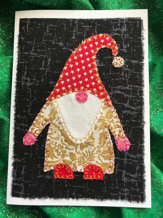 gold and red festive gnome christmas card on black