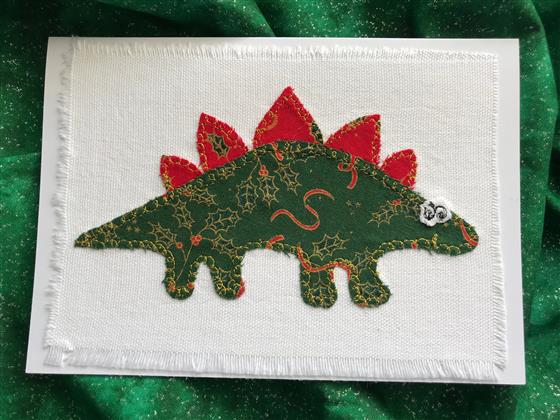 green festive stegosaurus christmas card on white