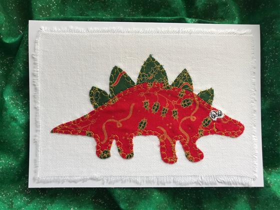 red festive stegosaurus christmas card on white