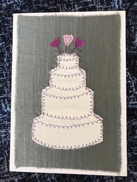 white wedding cake on grey silk greeting card