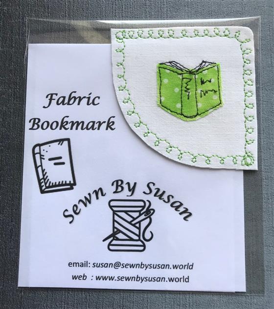 corner bookmark - green book on white fabric