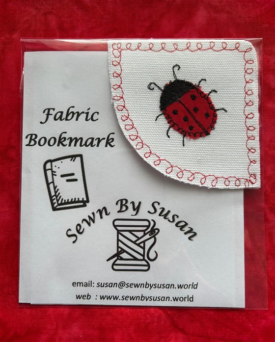 corner bookmark - ladybird on white fabric